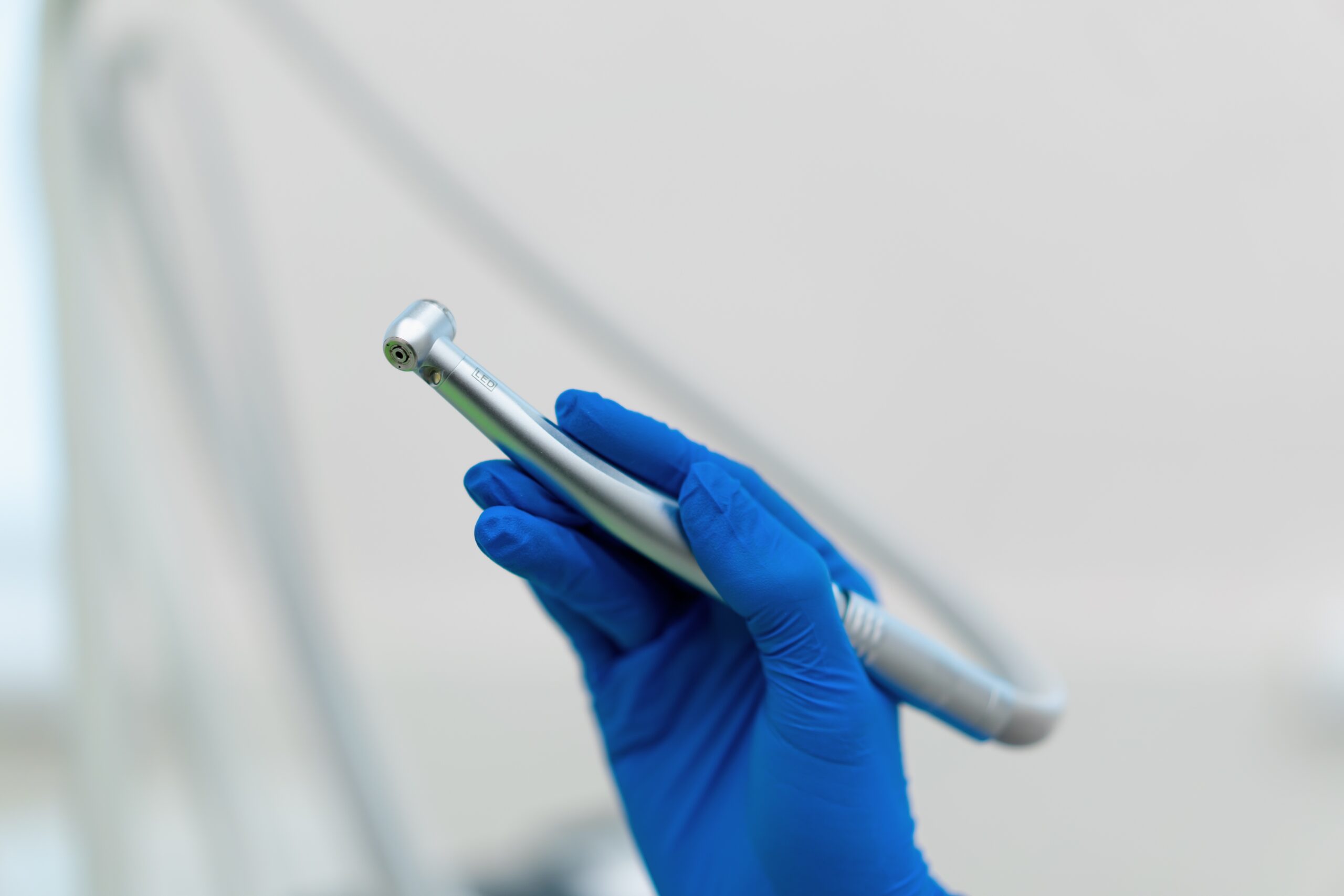 Professional,Dentist,Holding,Working,Tool,Dental,Turbine,Handpiece,In,Gloved