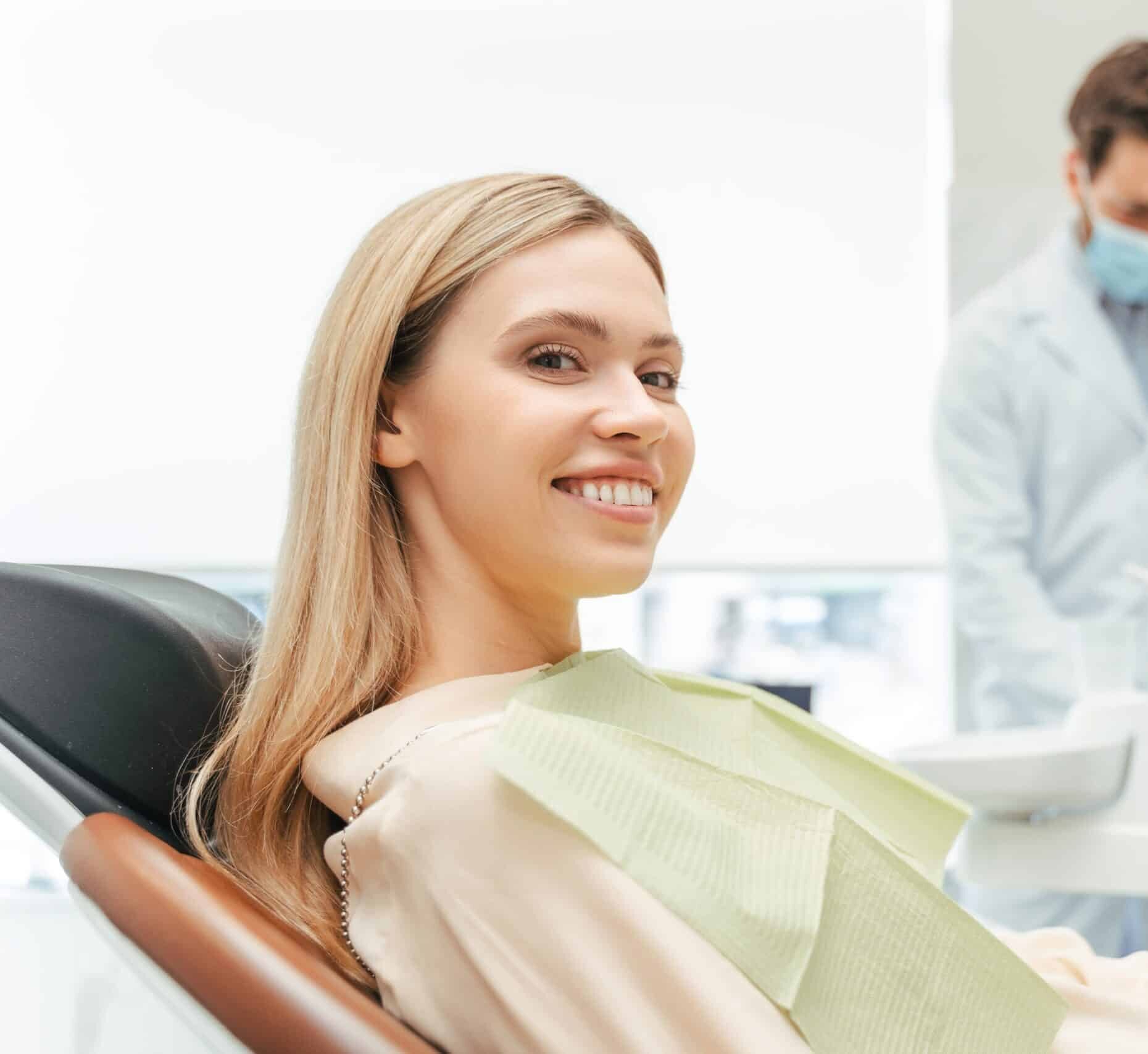 Young,Beautiful,Smiling,Woman,,Patient,Sitting,In,Modern,Dental,Clinic