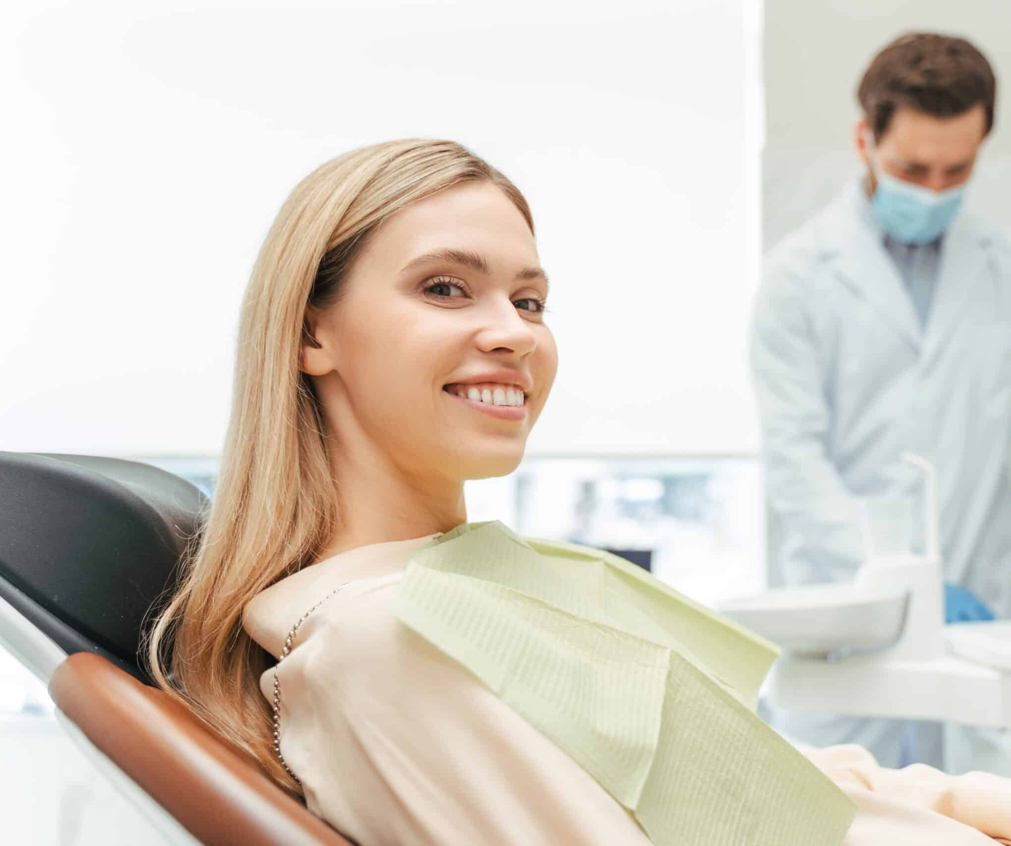 Young,Beautiful,Smiling,Woman,,Patient,Sitting,In,Modern,Dental,Clinic