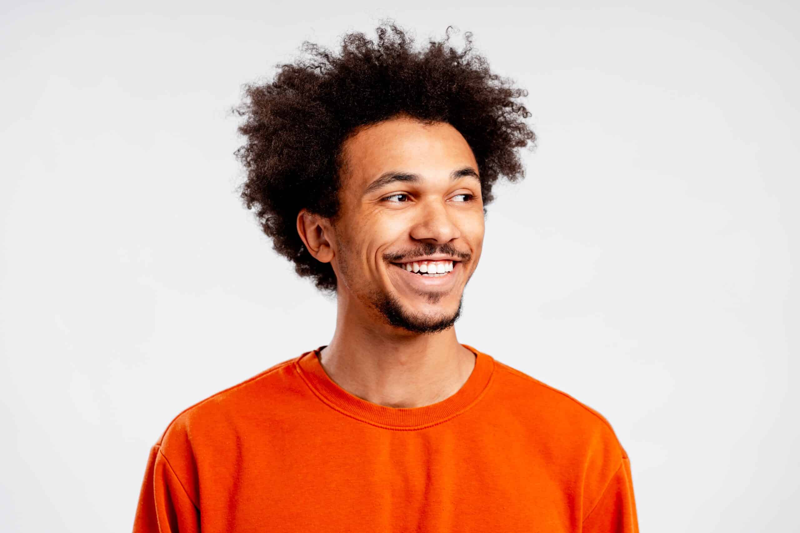 Young,Smiling,African,American,Man,With,Afro,Looking,Away,On