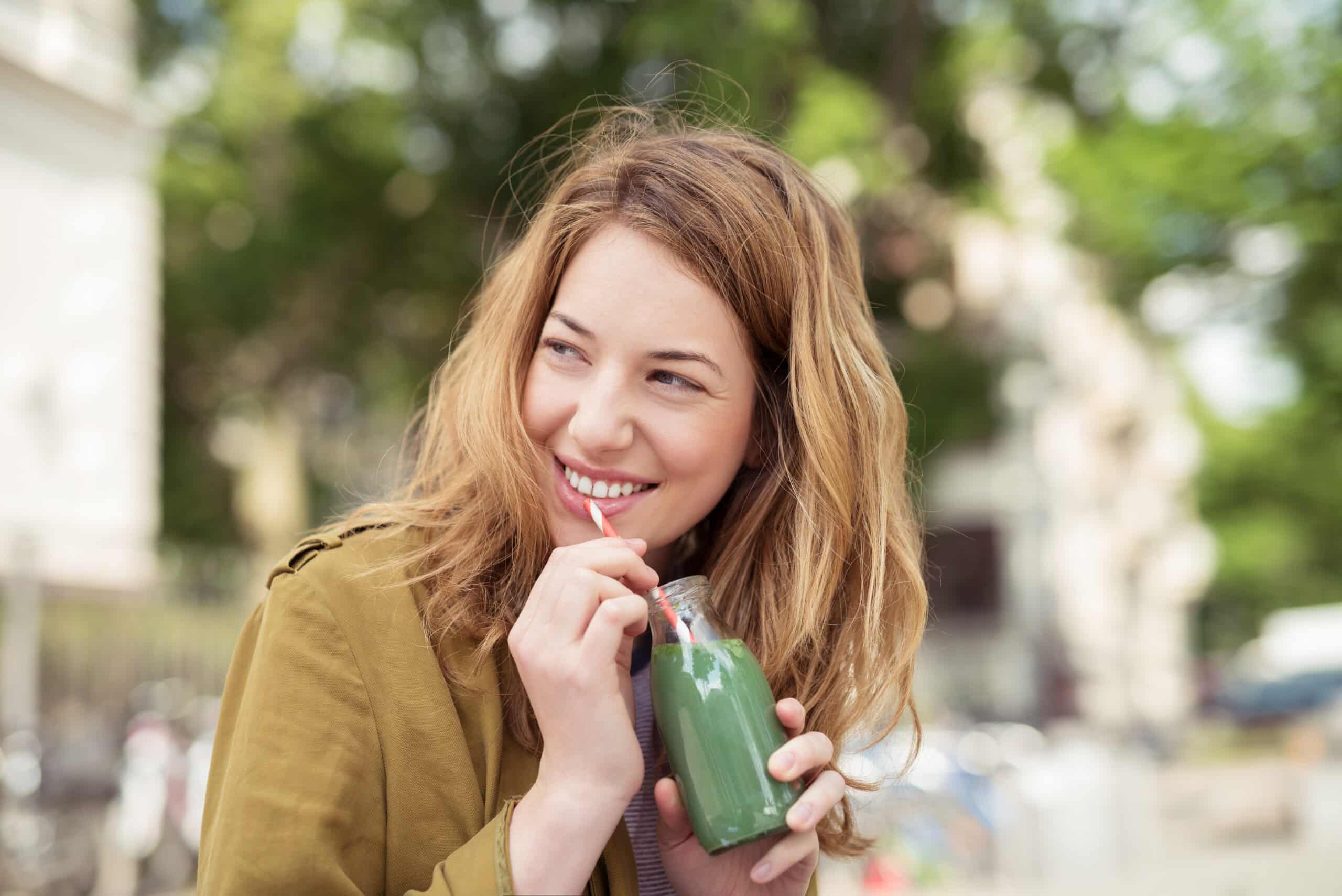 Pretty,Blond,Teen,Girl,Drinking,A,Bottle,Of,Green,Juice